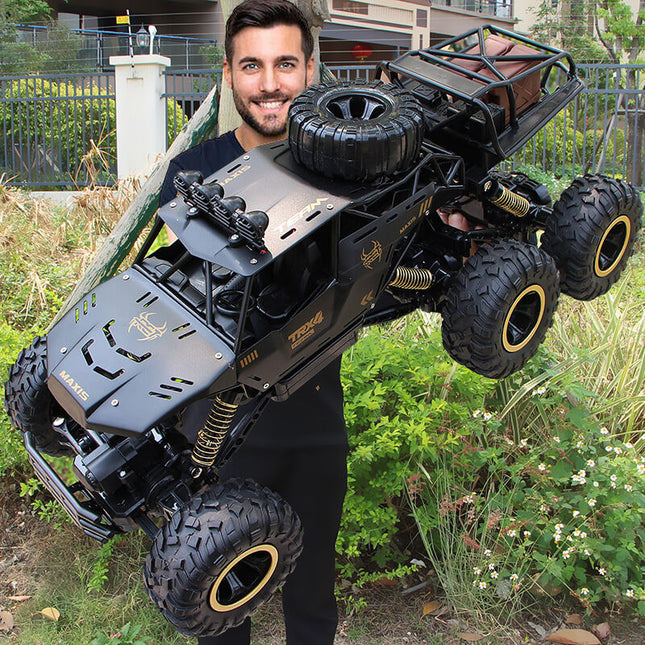 6x6 RC Monster Truck | 1/12 Schaal | All-Terrain Off-Road | 52 km/u | 2.4GHz Technologie | Schokbestendig | Antislipbanden | Zwart/Goud | Realistische Voorlichten | 7.4V 1200mAh Batterij | Voor Kinderen vanaf 6 Jaar | USB Opladen